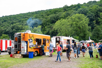 Crowds gathered by food trucks at the Garden Drive-In Theater