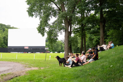 Groups sitting on the lawn at Garden Drive-In Theater