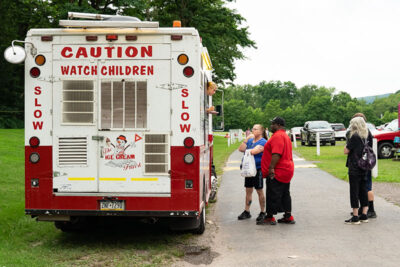 A couple orders ice cream from a truck