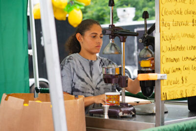 A woman making fresh squeezed lemonade