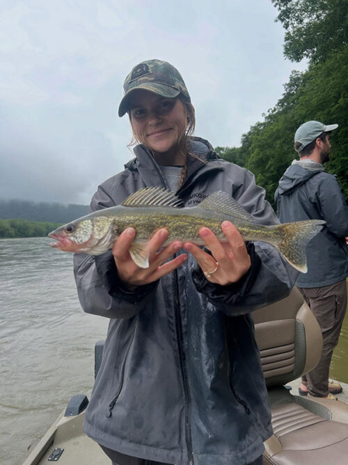 A young woman holds up a walleye she caught from the Susquehanna River with 2Fish Guide Service in Tunkhannock, PA.