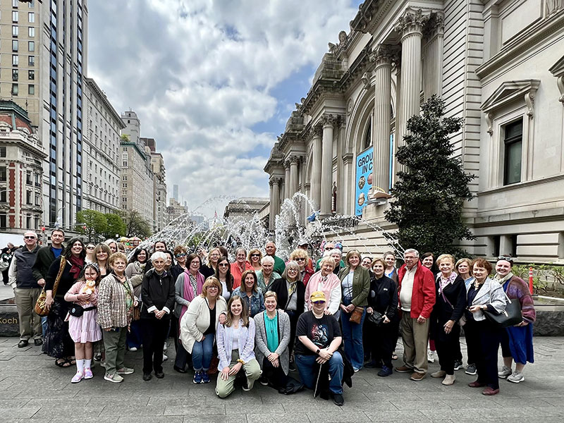 A large group of people pose for a photo while visiting New York on the Everhart Express excursion.
