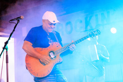 A guitar player smiles as he plays on stage during Rockin' the Mountain at City View Park in Hazleton, PA.
