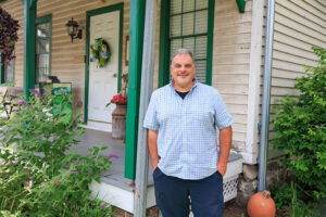Chet Mozloom, Executive Director of The Lands at Hillside Farms, stands in front of the administrative cabin in Shavertown, PA.