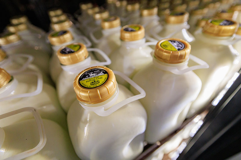 A collection of glass milk cartons sit filled with chocolate milk at the Lands at Hillside Farms in Shavertown, PA.
