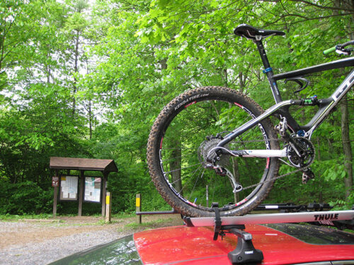 A mountain bike mounted on the top of a red vehicle at Swatara State Park in Pine Grove, PA.