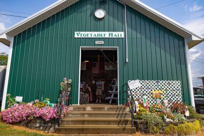 A green barn with a sign that reads 