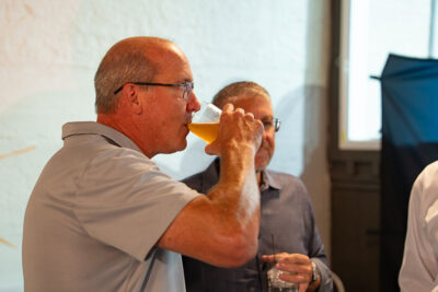 A man drinks a beer from Runaway Train Brewery