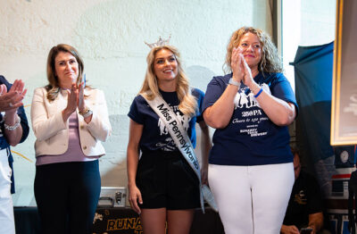 A group listens to a speaker at Runaway Train Brewery