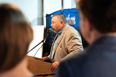 Justin Genzlinger speaks at a podium