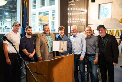 Owners and brewers of Runaway Train Brewery pose with Representative Rob Bresnahan