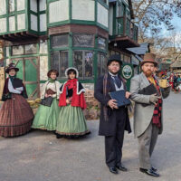 Costumed actors pose on a street corner during the holiday celebrations in Mount Hope, PA.