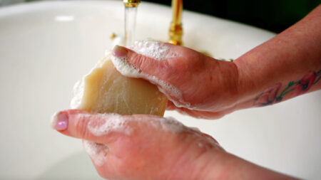 Hands sudsing up a bar of locally made soap from Edie Mae's Soap in Hunlock Creek, PA.