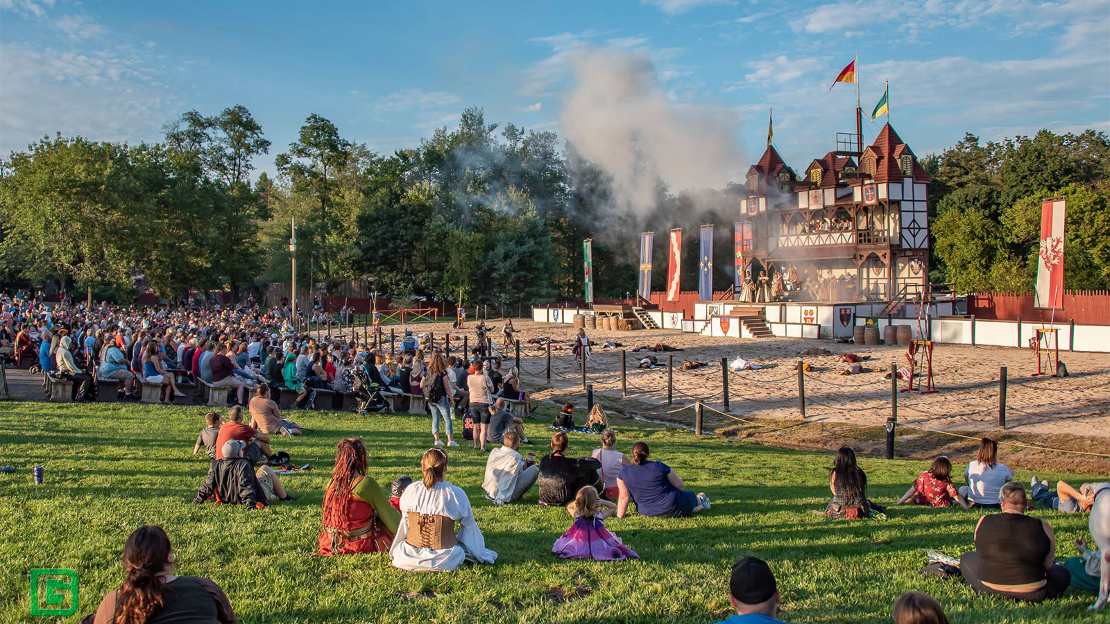 A crowd of people sitting in the lawn at the Shire at Mount Hope at the PA Renaissance Faire.