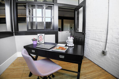 A view into the den/office space inside a fully-furnished apartment in the Waterfront Warehouse in Pittston, PA.