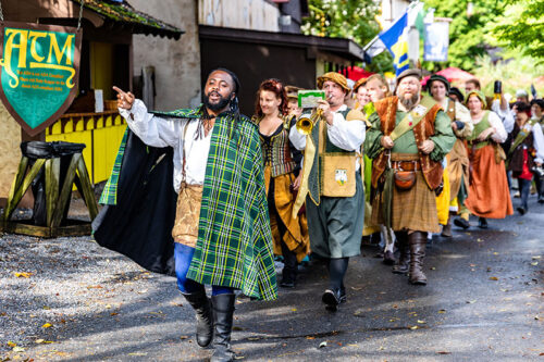 A parade of people in costume at the PA Renaissance Faire in Mount Hope, PA.