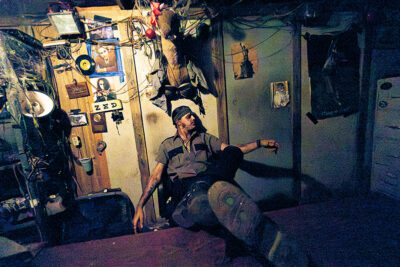 An actor dressed dressed as a bloodied sheriff sits back in his chair with his feet up on the desk and addresses the crowd at Reaper's Revenge in Scott Twp., PA near Scranton.