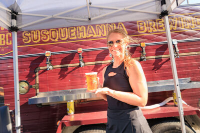 A bartender holds up a freshly poured beer for the camera during the Boots & Brews Music Festival at Clubhouse 315 in Wilkes-Barre, PA.