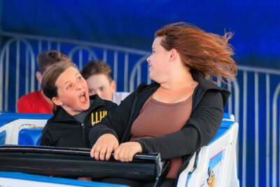 A girl makes a face at another girl as they enjoy the rides at the Luzerne County Fair in Dallas, PA.