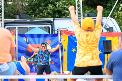 A circus member pumps up the crowd at the Luzerne County Fair in Dallas, PA.