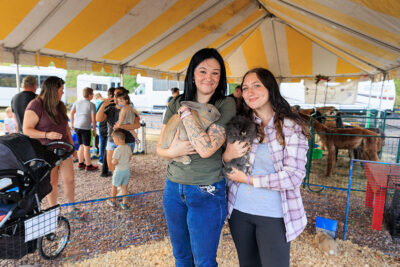 Two girls smile for the camera while holding bunnies at the Luzerne County Fair in Dallas, PA.