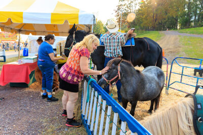 A woman pets a donkey at the Luzerne County Fair in Dallas, PA.