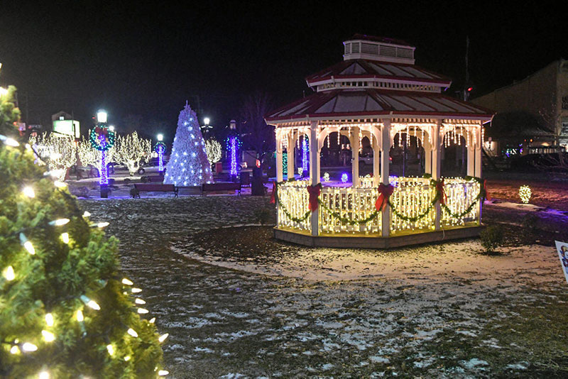 Tamaqua’s Spirit of Christmas Festival in Tamaqua, PA, featuring a gazebo and park covered in twinkling holiday lights and decorated trees.