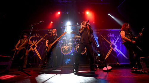 Rock band Queensrÿche performs live under red stage lights; they will perform at the F.M. Kirby Center in Wilkes-Barre, PA.
