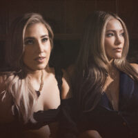 Maddie & Tae promotional image for their Love & Light Tour concert at the Sherman Theater in Stroudsburg, showing the duo in a softly lit portrait-style photo.