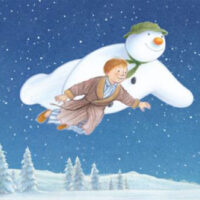 Illustration for The Snowman™ in Concert presented by The Northeastern Pennsylvania Philharmonic in Wilkes-Barre, PA, showing the boy and the snowman flying together over a snowy landscape under a starry winter sky.