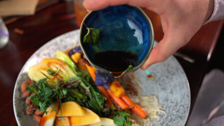 A colorful vegetable and rice dish drizzled with sauce at Alter House in Clarks Summit, PA.