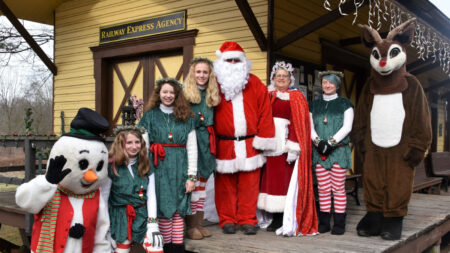 WK&S Santa Claus Express in Kempton, PA, with Santa, Mrs. Claus, holiday characters, and helpers posing in front of the historic train station.