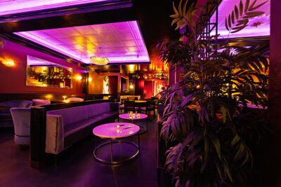 A view of the lounge area with couches and comfy seating at Madame Jenny's in Scranton, PA.