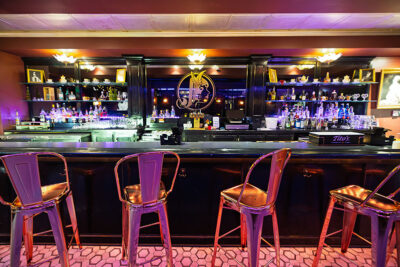 A view looking at the cocktail bar and stools inside Madame Jenny's in Scranton, PA.