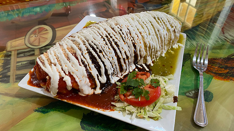 The large burrito from Hacienda Volcan in Scranton, PA taking up the entire plate on the table.