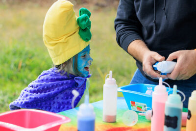 A girl dressed as a smurf watches excitedly as sand is about to get poured into a sand art bottle at Dymond's Farm and Farm Market in Dallas, PA.