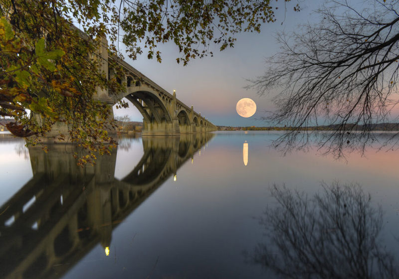 A huge full moon rising over the Susquehanna River in Columbia, PA.