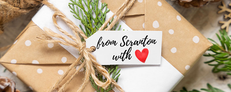 A wrapped gift box with a tag that reads: "From Scranton with Love."