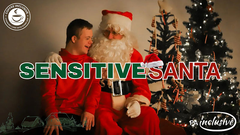 Promotional image for a Sensitive Santa event at Coffee Inclusive showing a child smiling while sitting beside Santa in front of a decorated tree, with the event title overlaid on the photo.