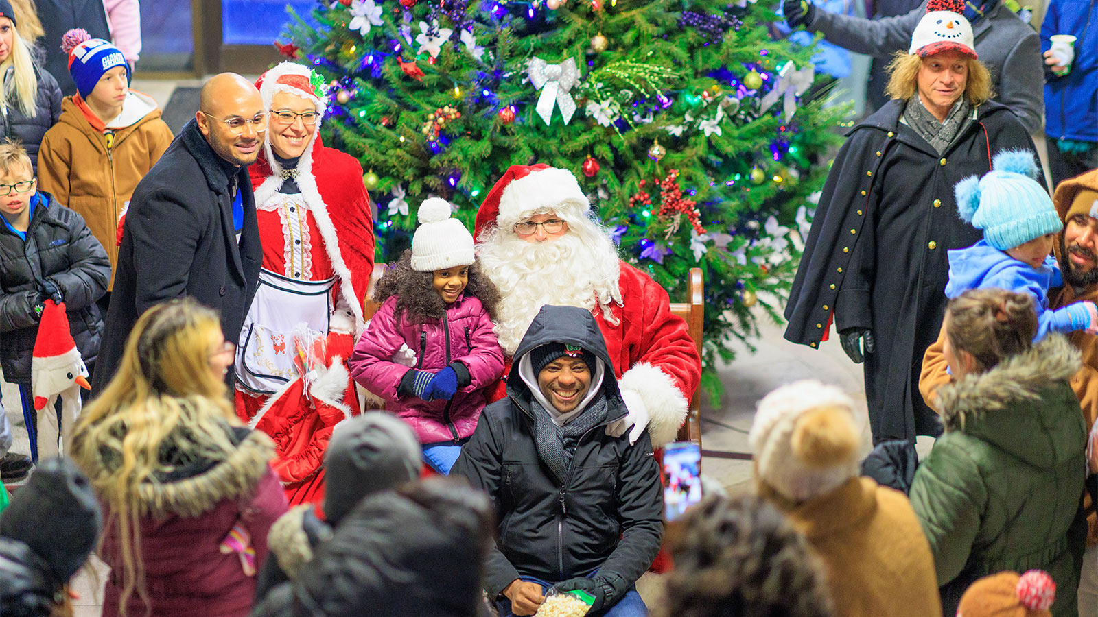 A family gathered around Santa and Mrs. Claus for a photo at the Hazleton City Hall Holiday Celebration.