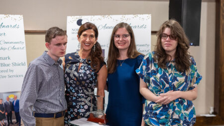 A group of award recipients and a staff member from Northeast Sight Services smile together at the Annual Awards Dinner.