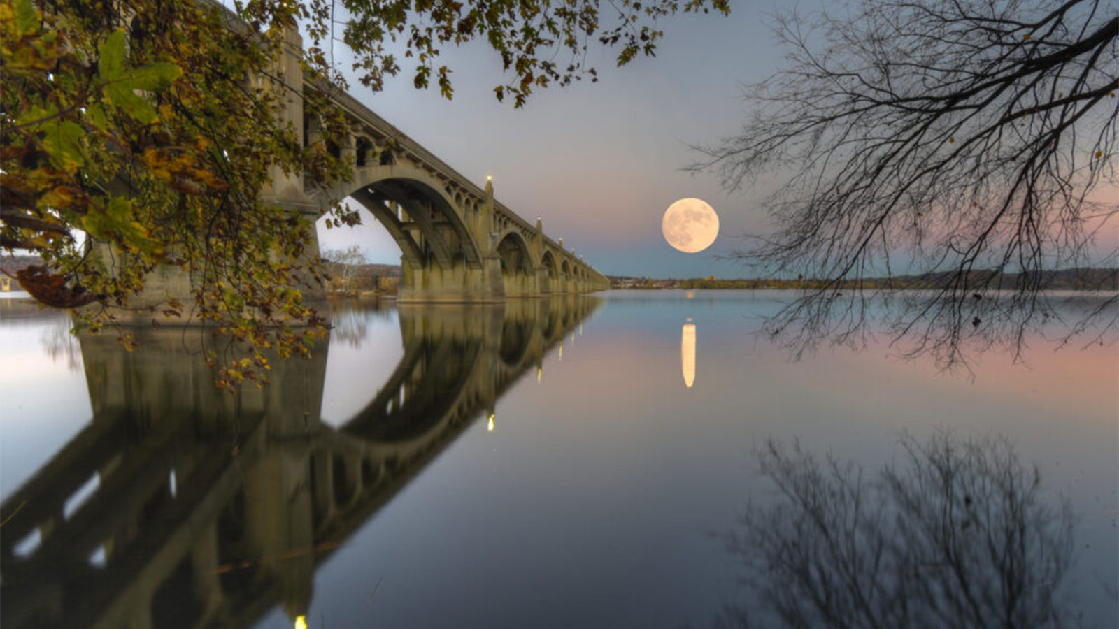 A huge full moon rising over the Susquehanna River in Columbia, PA.