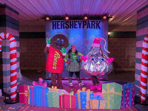Reese's and Hershey Kiss dancing on a decorated stage at Hersheypark Christmas Candylane in Hershey, PA.