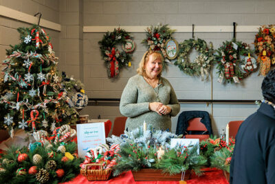 A smiling vendor at the 2025 Artisans' Marketplace at the Waverly Community House