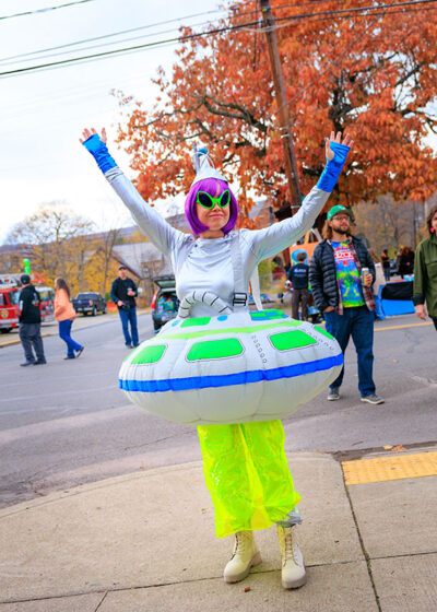 A woman dressed as an alien wearing an inflatable UFO costume poses for the camera at the second annual Carbondalien Festival in Carbondale, PA.