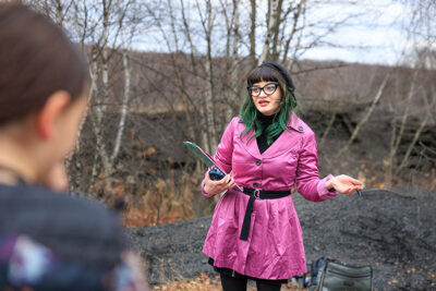 An actor dressed as a UFO investigator talks to the crowd at the second annual Carbondalien Festival in Carbondale, PA.