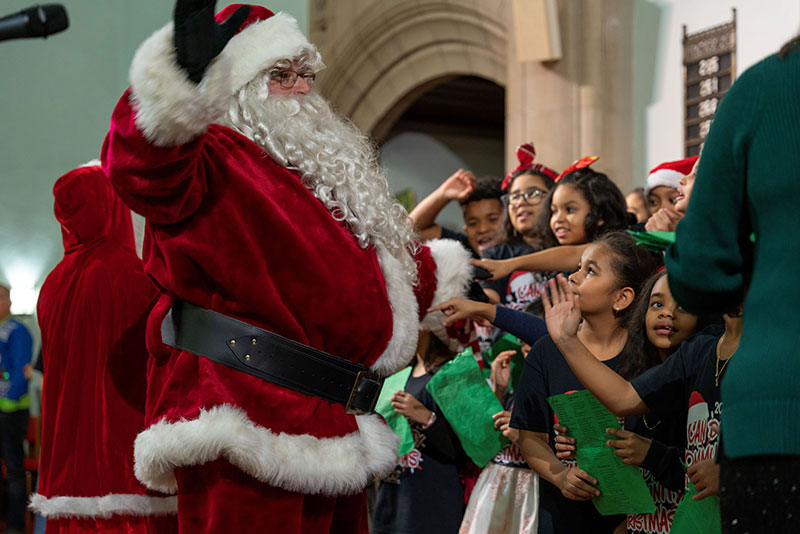 Santa greets children gathered around him at the CAN DO Community Christmas event in Hazleton, PA.