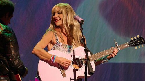 Say Yes to Love Story: An Unofficial Tribute to Taylor Swift will perform live at the F.M. Kirby Center for the Performing Arts in Wilkes-Barre, featuring a performer singing and playing guitar under colorful stage lights.