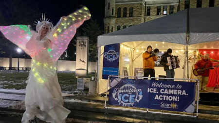 A performer on stilts entertains the crowd at Downtown on Ice in Scranton, PA.
