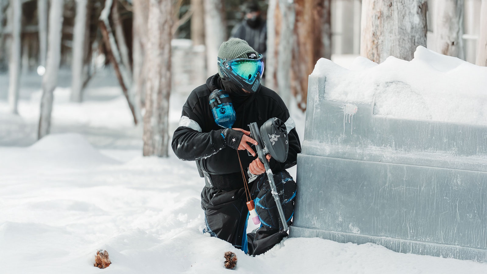 A paintball player shelters in the snow at Skirmish Paintball in Albrightsville, PA.